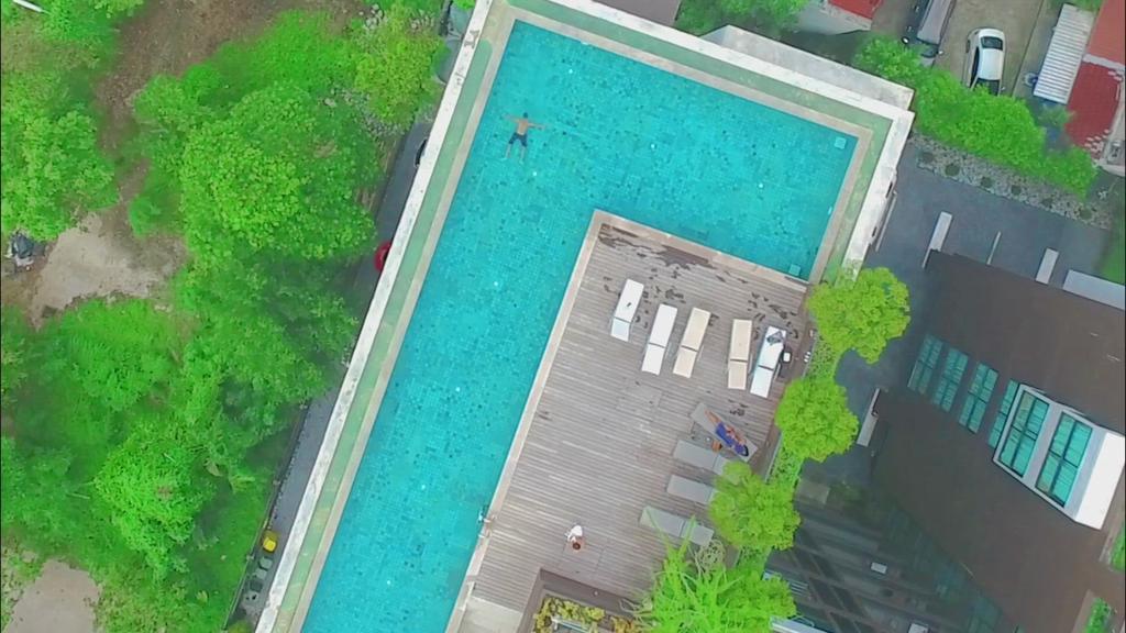 'Video thumbnail for Drone shot from Man swimming in a Large Pool'