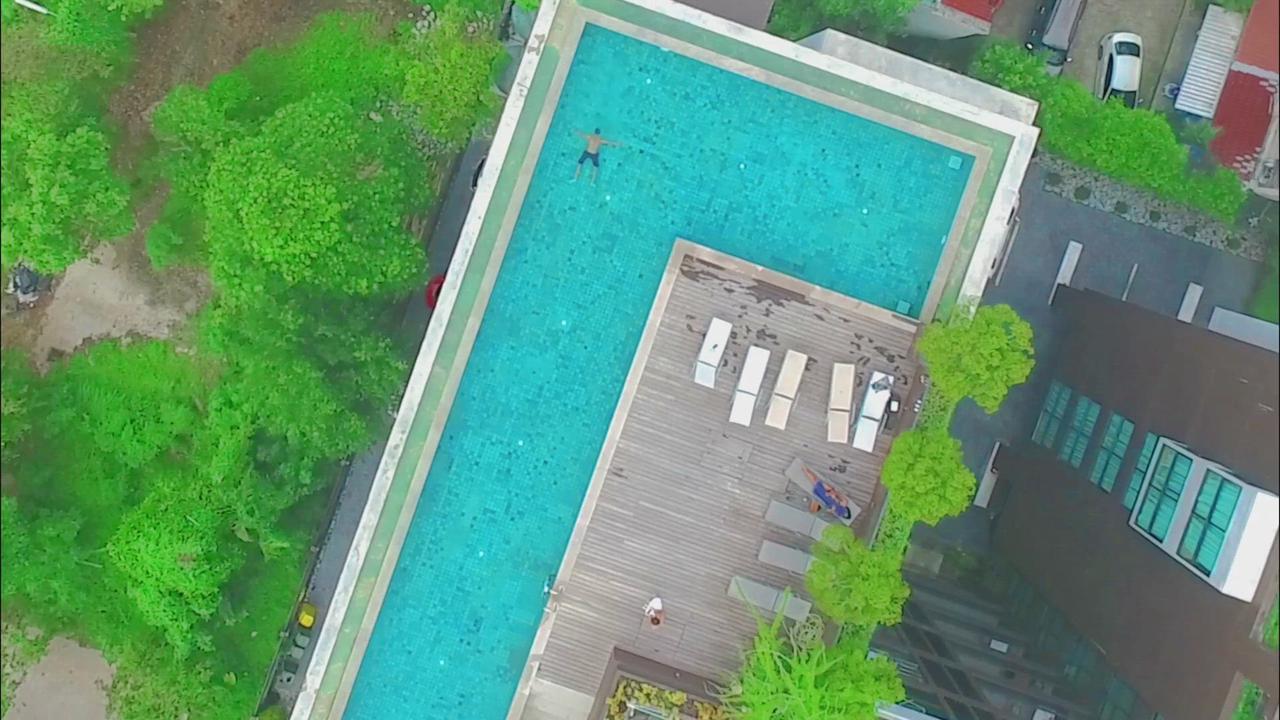 'Video thumbnail for Drone shot from Man swimming in a Large Pool'